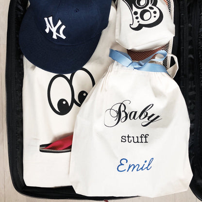 Bag-all personalized Baby Stuff organizer bag with NY Yankees cap, featuring custom name Emil, white cotton drawstring pouch with blue ribbon accent for nursery storage