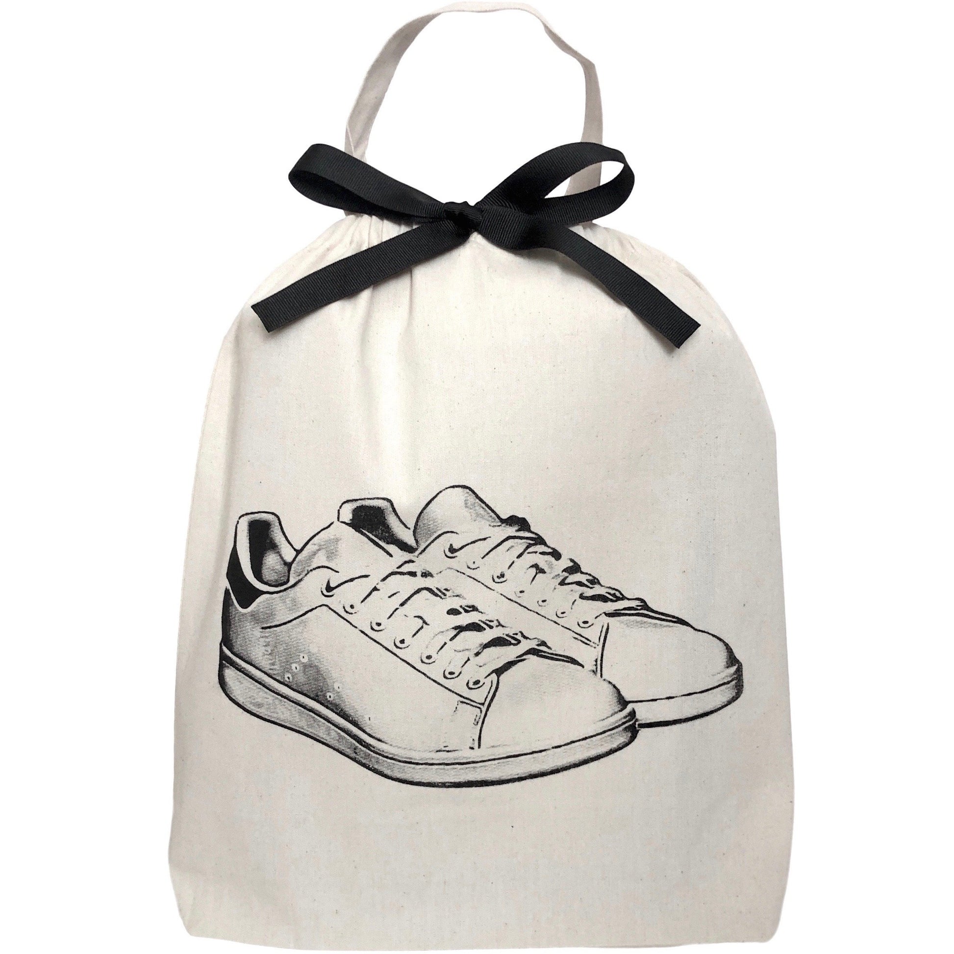 Bag-all White Sneaker Shoe Bag in cream cotton featuring black bow and hand-drawn sneaker design, with drawstring closure and carrying handle for stylish footwear storage