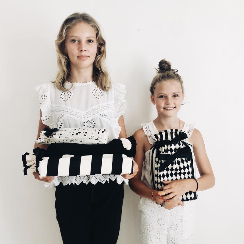 Bag-all Gift Bag Black Medium and striped pattern gift bags showcased in black and white designs for sustainable, reusable gift wrapping solutions