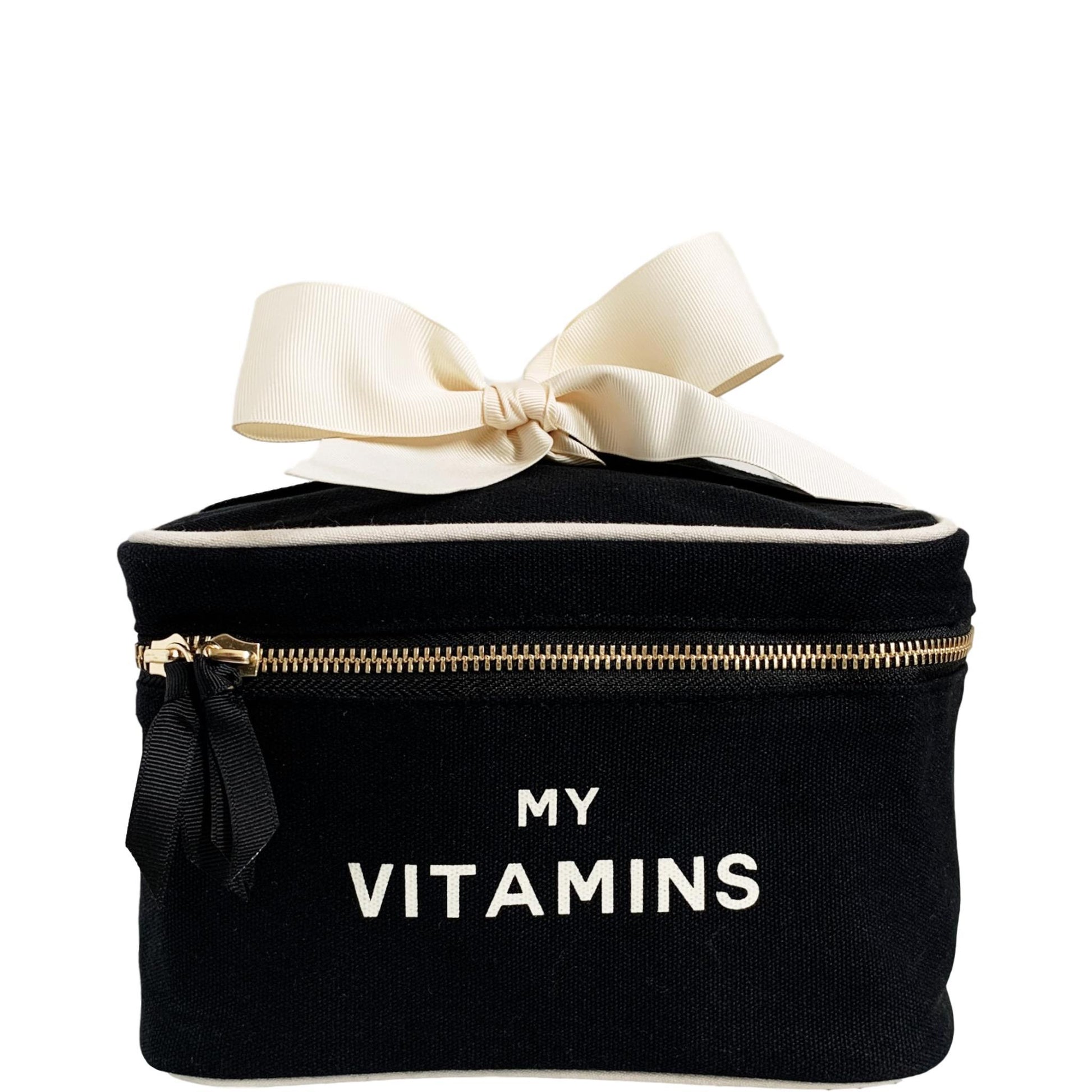 Bag-all Vitamins Storage and Travel Box in black canvas with cream bow, featuring "MY VITAMINS" text and gold zipper, perfect for organizing supplements on-the-go