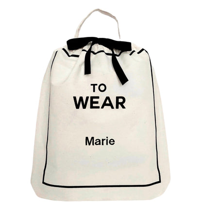 Bag-all To Wear Outfit Bag in cream cotton with black text, drawstring closure and carrying handle - perfect for organizing daily travel outfits
