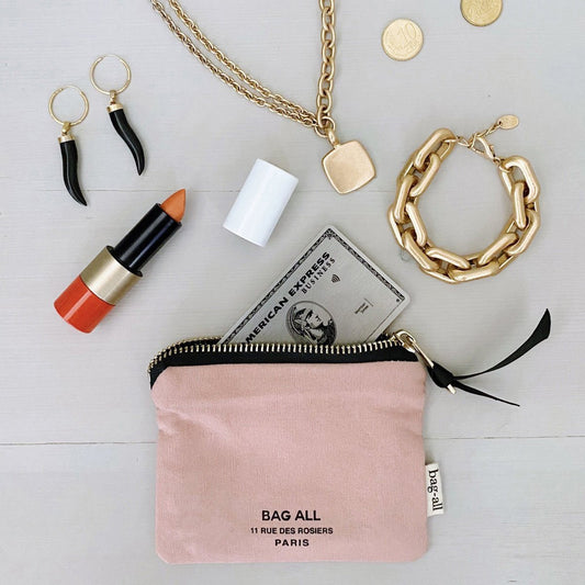 Bag-all Mini Trinket Pouch in pink canvas with black zipper, styled with gold jewelry, lipstick, and credit card - perfect for organizing small essentials and personal items