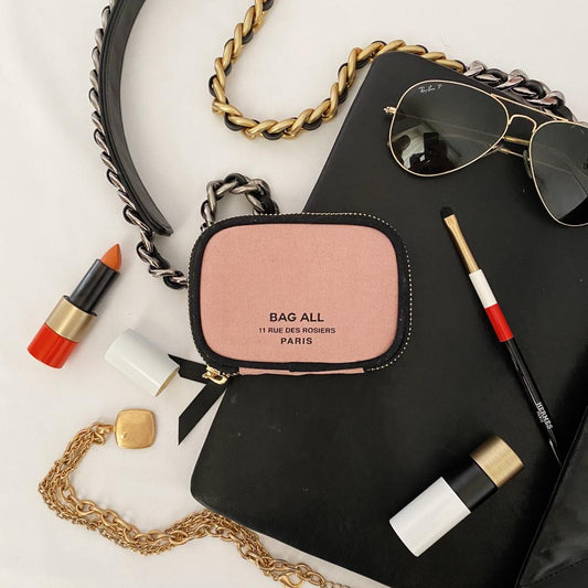 Bag-all Small Wallet Pink/Blush with Black Piping featuring gold metal zipper, styled with aviator sunglasses, lipstick, and gold chain accessories on white background, perfect for everyday essentials