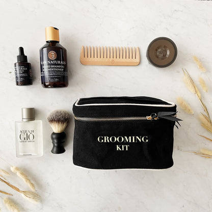 Bag-all Grooming Kit Box Black with premium grooming essentials including natural products, wooden comb, shaving brush, and golden zipper closure on marble background