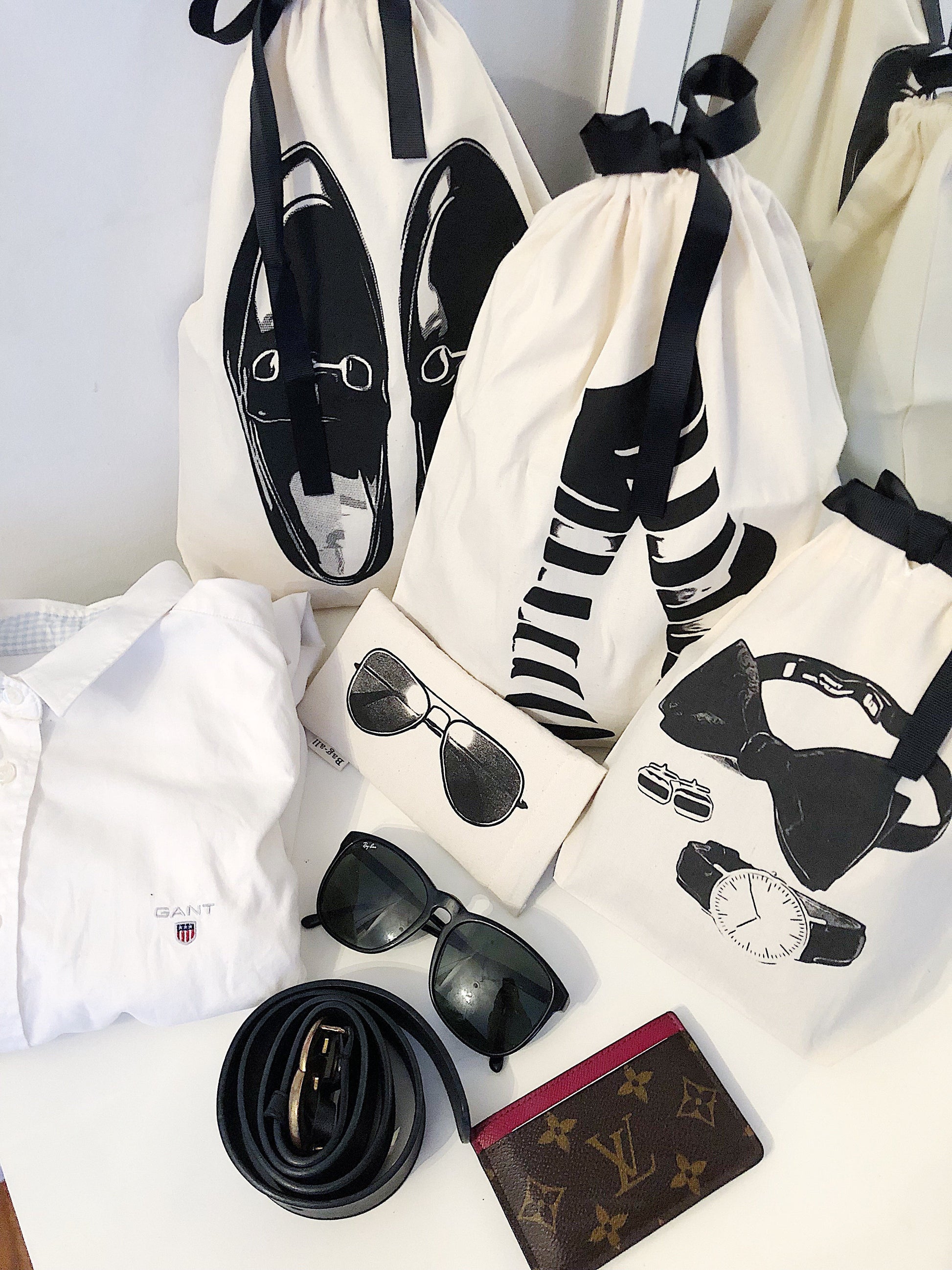 Bag-all Loafers Moccasin Shoe Bag in cream cotton featuring black shoe design print, displayed with luxury accessories and matching organizing bags, perfect for travel and storage