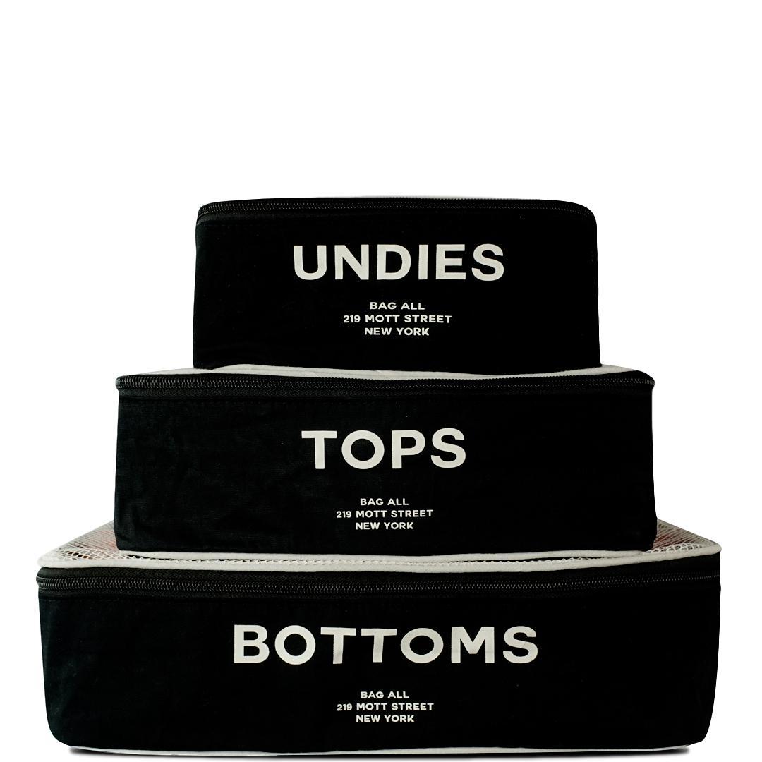 Bag-all Cotton Packing Cubes 3-pack in Black with white mesh top, featuring UNDIES, TOPS, BOTTOMS text print - organized travel storage solution with breathable design