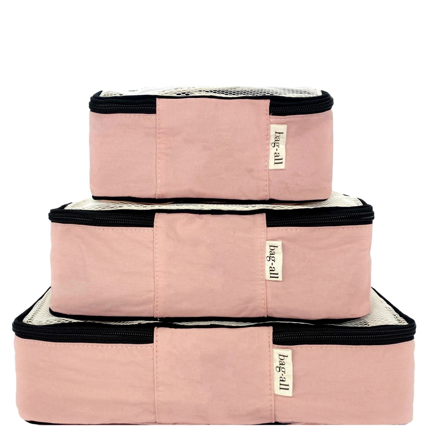 Bag-all Cotton Packing Cubes 3-pack in Pink/Blush, featuring mesh tops and black zippers. Stackable travel organizers in different sizes for efficient suitcase organization.